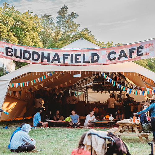 Fabric sign that says 'Buddhafield Cafe' above a venue