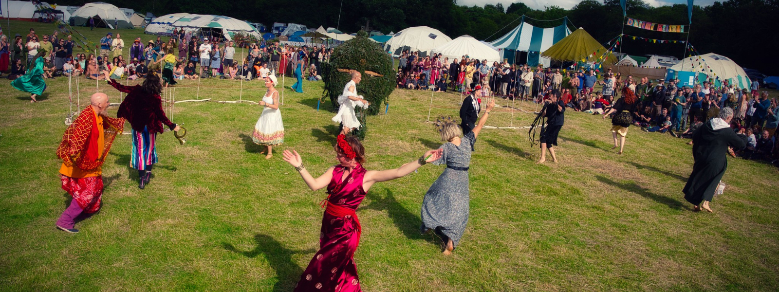 People dancing in a field at Buddhafield Festival 